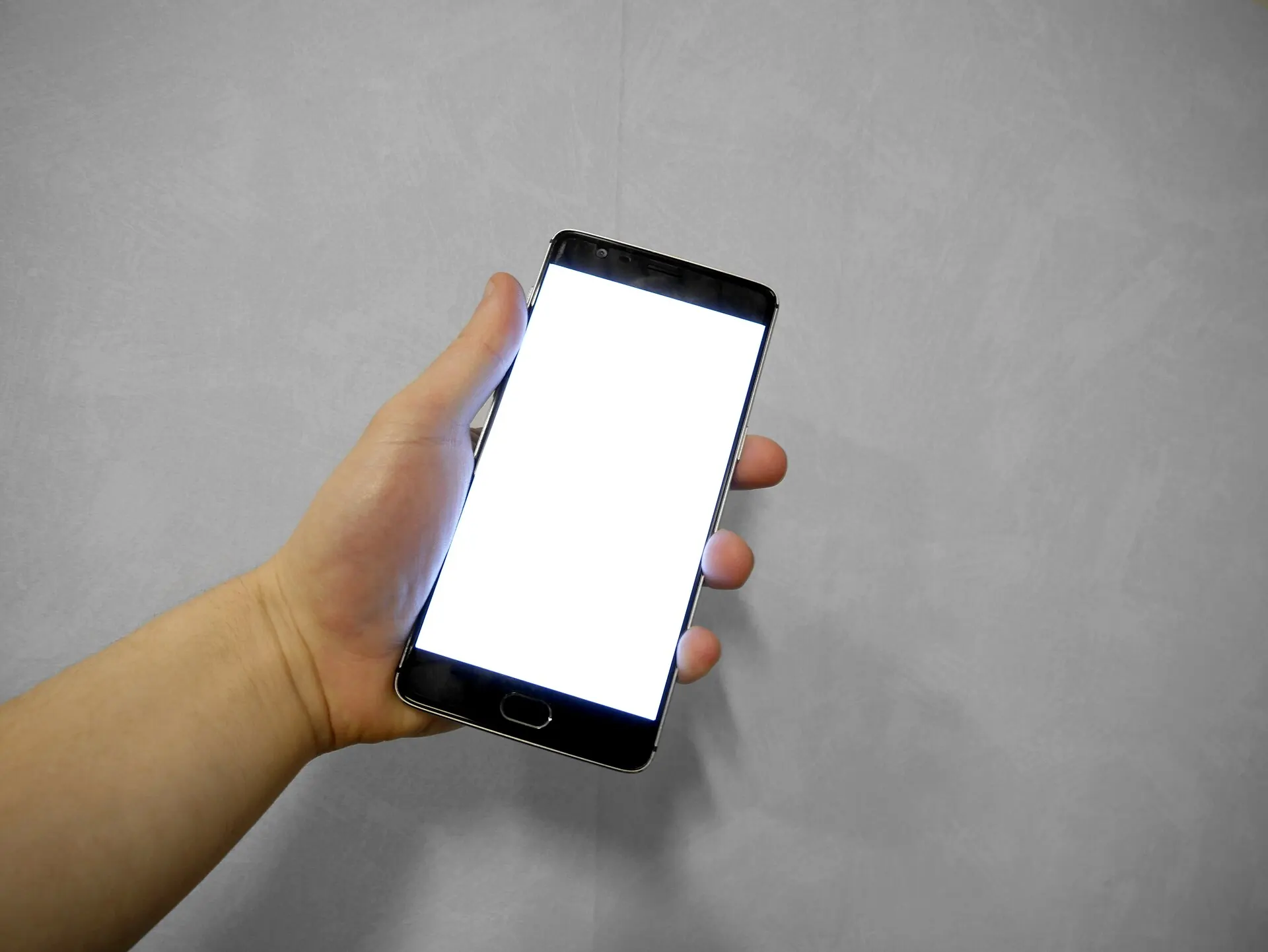 A hand holding a phone